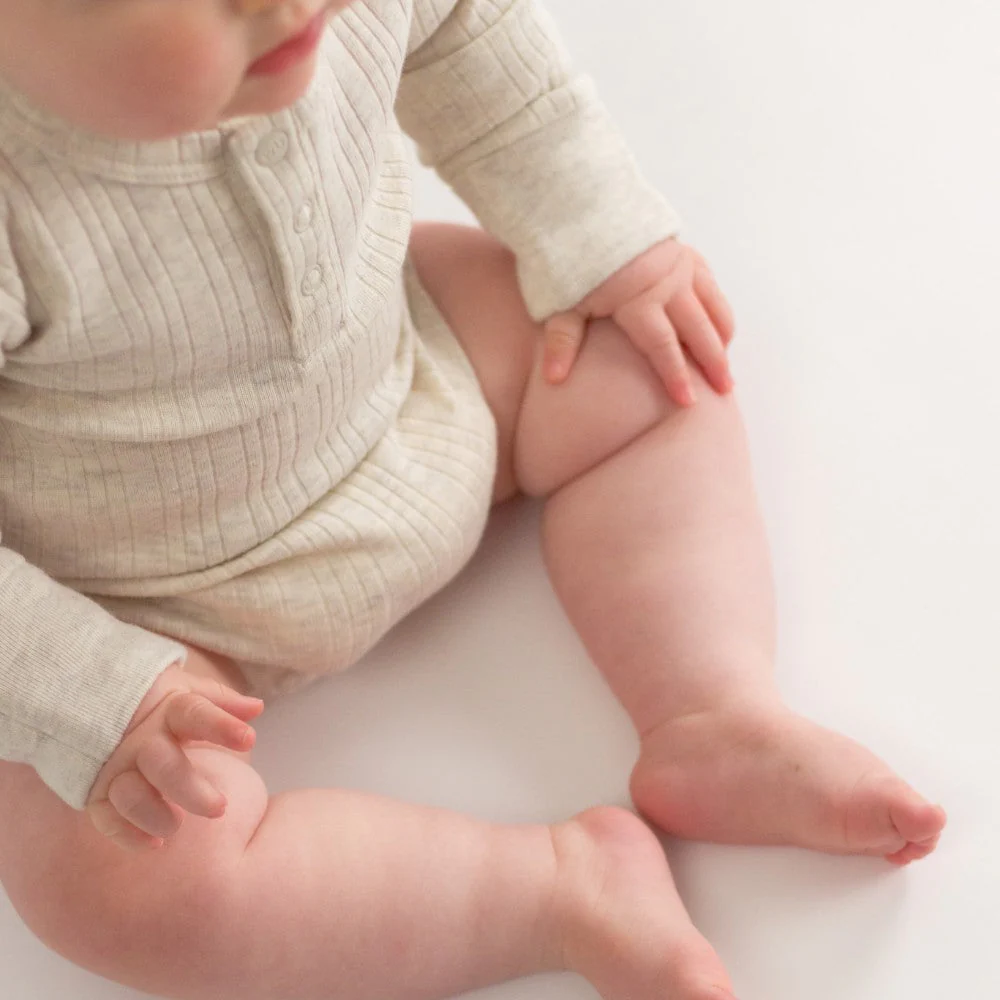 Woolbabe Organic Cotton/Merino Long Sleeve Henley Bodysuit Natural Marl - Image 6